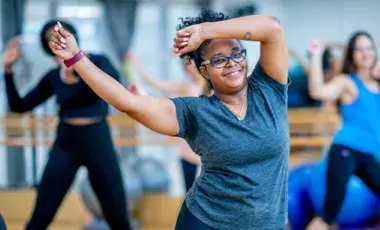 Women are waving their arms while exercising.