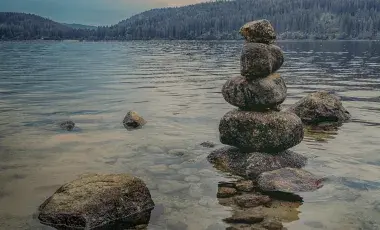 rocks stacked at the shore of a lake