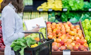 A woman shopping for vegetables in the produce section.