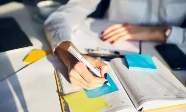 hands writing in journal