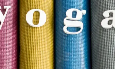 4 colorful yoga mats, rolled up