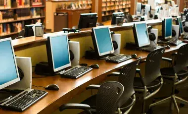 A row of computers in a library
