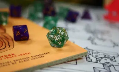 A handful of many sided dice rolled on a table.