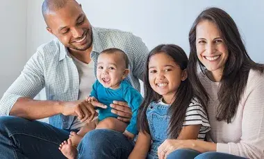 Mother and father sitting with two children