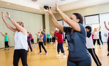 Women are raising their arms while exercising.