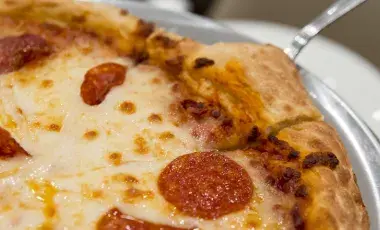 An up-close image of a pepperoni pizza