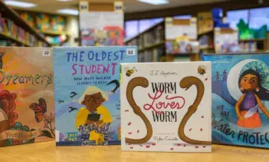 Children's Picture Books shown on a wooden table.