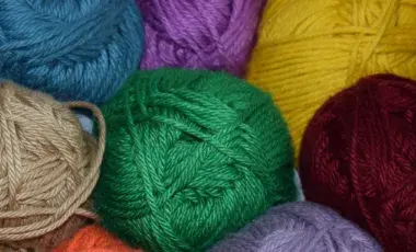 several skeins of colored yarn in a pile