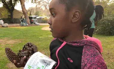 a kid participating in a biometry class outside the library