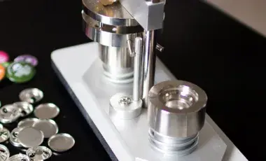 image of a button press next to a pile of unmade buttons