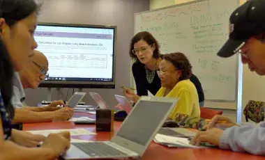 Adult learners learning in a class room setting.