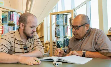 Adult literacy student and teacher 