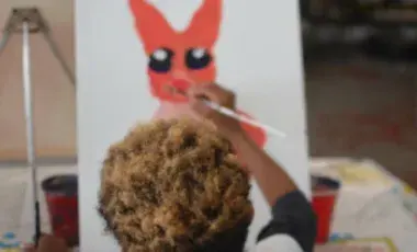 Child painting on a canvas. 