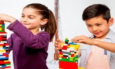 Two kids building with legos