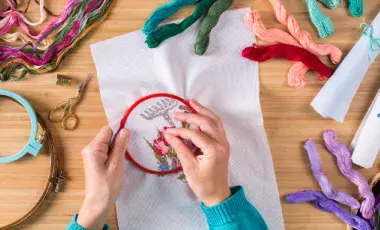 a person works on an embroidery project 