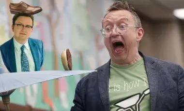 Michael Rayner juggles a cheeseburger on a parasol