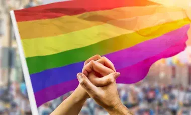 rainbow flag and hands holding