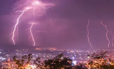 lightning flashes over city scape