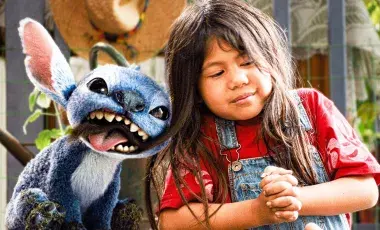 blue character and little girl next to each other