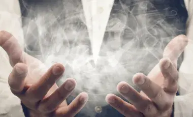 hands with wispy smoke floating out of them like magic