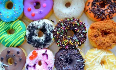 a dozen colorful donuts