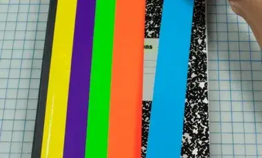 Image of a notebook being decorated with craft tape