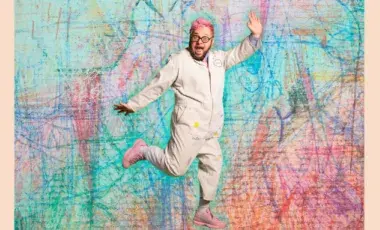 Ricky Rainbow Board jumping in front of a colorful background. 