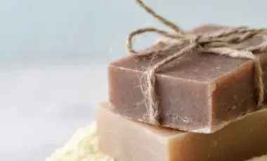 Two brown blocks of soap on a cream towel
