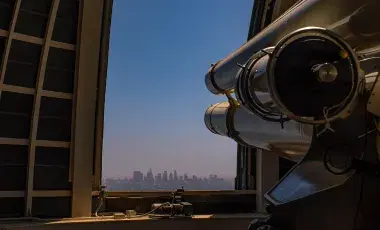 telescope at griffith observatory pointing out at the city of Los Angeles skyline