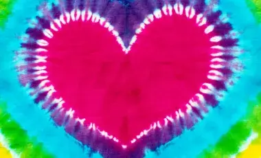 A multicolored tie-dye design in the shape of a heart.