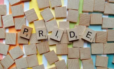 Scrabble letters that spell PRIDE