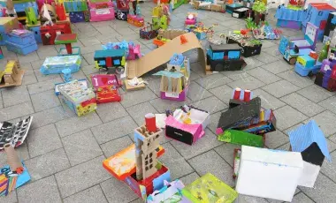 A colorful cardboard city made from recycled boxes 