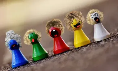 A color photo of multicolored game pieces with hair and faces, Image by Alexas_Fotos from Pixabay