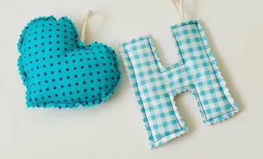 heart shape blue with black polka dots and letter H with blue and white checker pattern both made of  fabric 