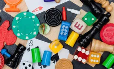 Cards and game tokens on top of a checked board