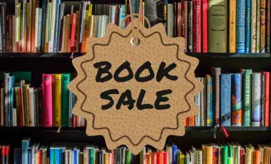 bookshelf with sign reading book sale
