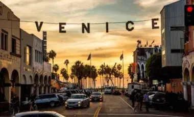 Venice Beach sign against a sunset
