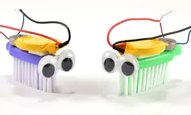  2 Bristlebots face each other, tiny robots built on the head of a toothbrush!