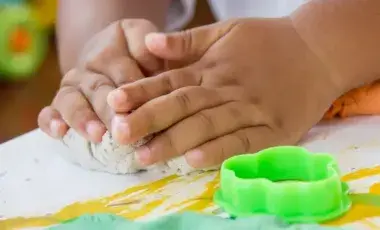 kids hands playing with playdough