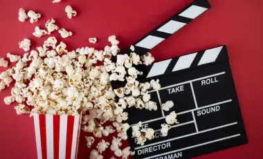 Popcorn spread out and a clapperboard.