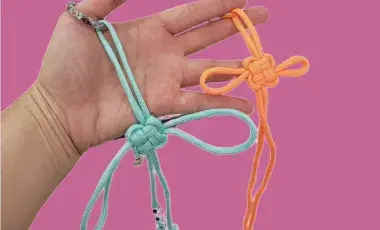 a hand displaying two traditional korean knots 