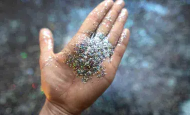 Hand holding colorful glitter