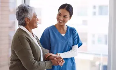A medical staff person holding a person's arm.