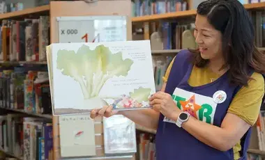 STAR reader holding picture book