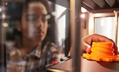 Child making a 3D printed object. 
