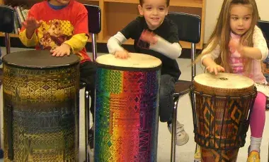 CHILDREN DRUMMING.
