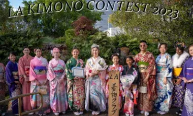 Several individuals stand in a row wearing bright kimonos