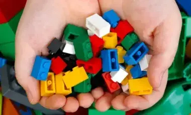 2 cupped hands holding legos