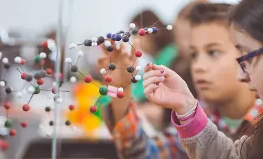 Children with a molecule model