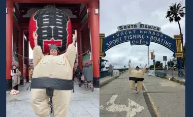 Woman in Sumo costume in front of two landmarks. 